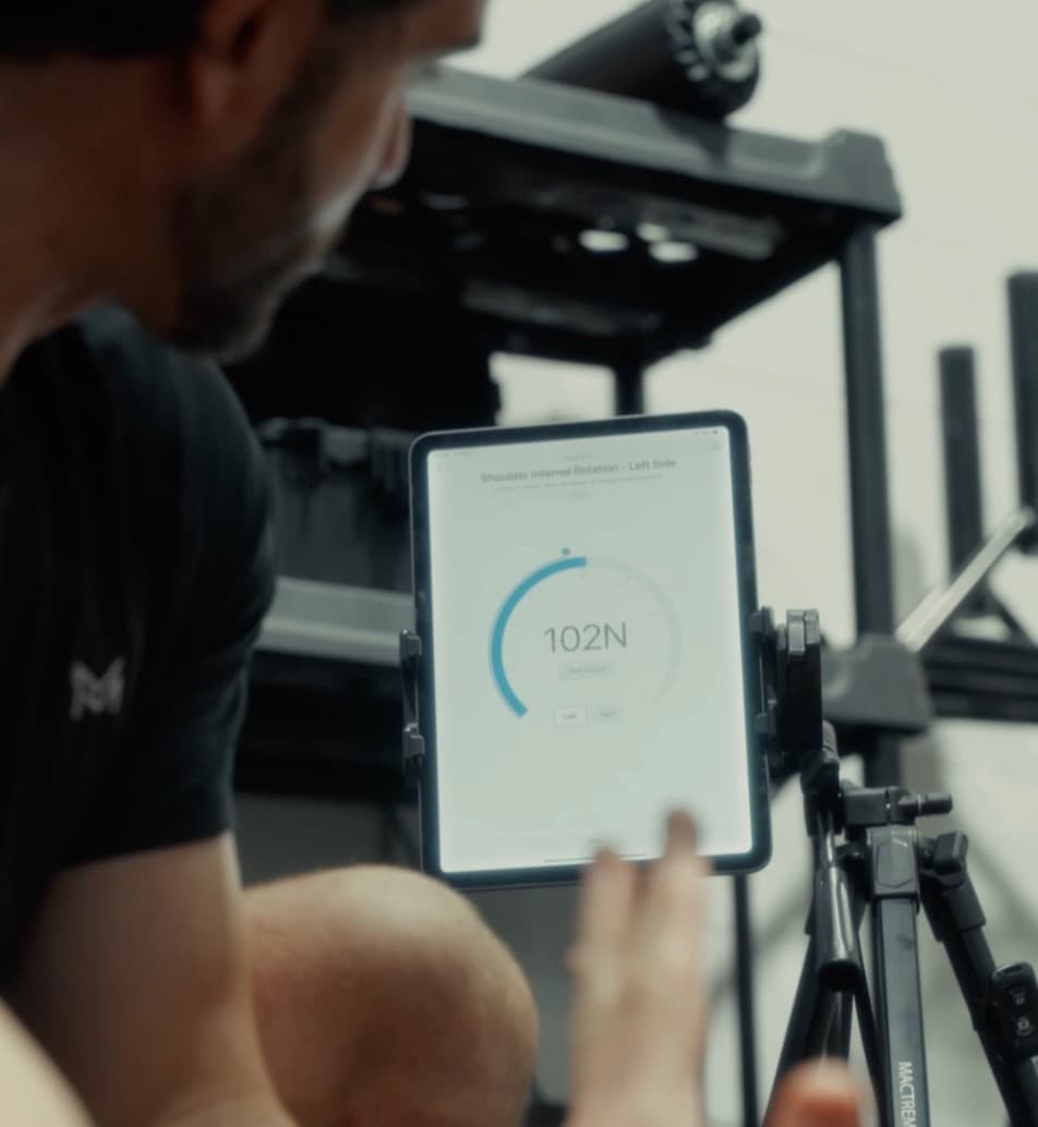 Sports physical therapist guiding an athlete through movement assessment at Movement Medicine in Atlanta